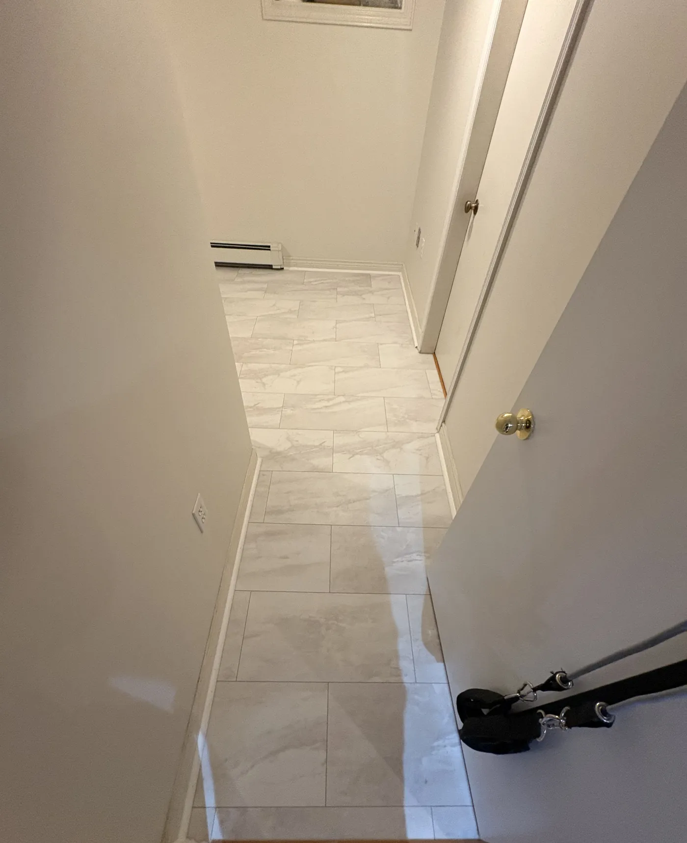 Finished marble-look tile running the length of a hallway